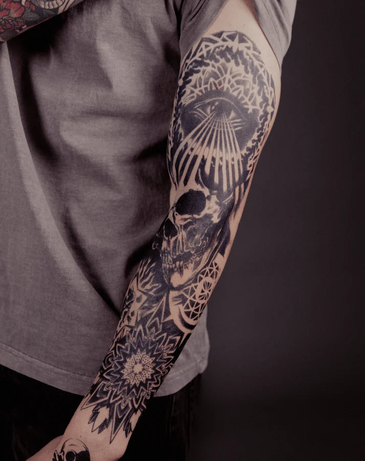 Skull and all seeing eye full sleeve tattoo on arm